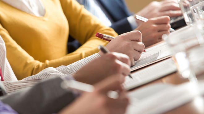 Business people writing on paper